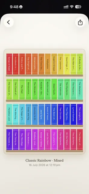 A rainbow shelf sorted title A–Z, every spine the same height, in a light room.